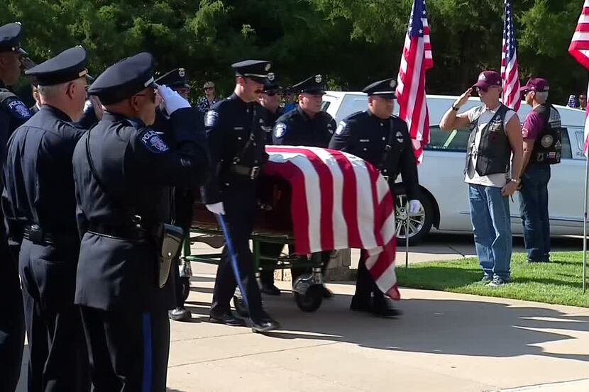 Police salute SMU Officer Mark McCullers during a burial ceremony Monday at Dallas-Fort...