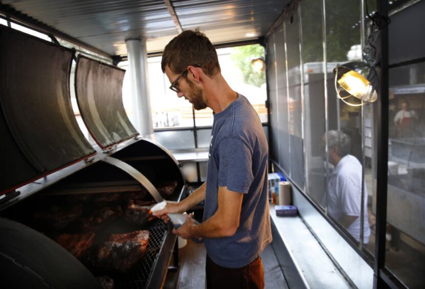 La Barbecue pitmaster John Lewis tends to briskets on his new smoker in Austin.