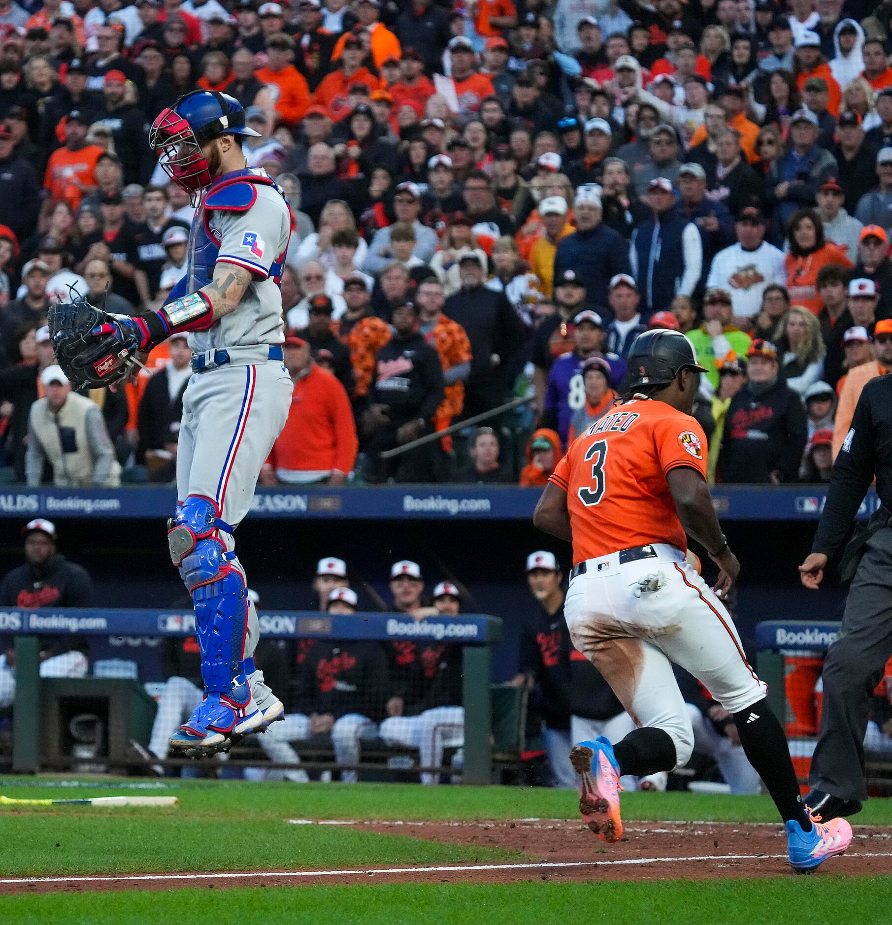 Baltimore Orioles shortstop Jorge Mateo scores past Texas Rangers catcher Jonah Heim during...