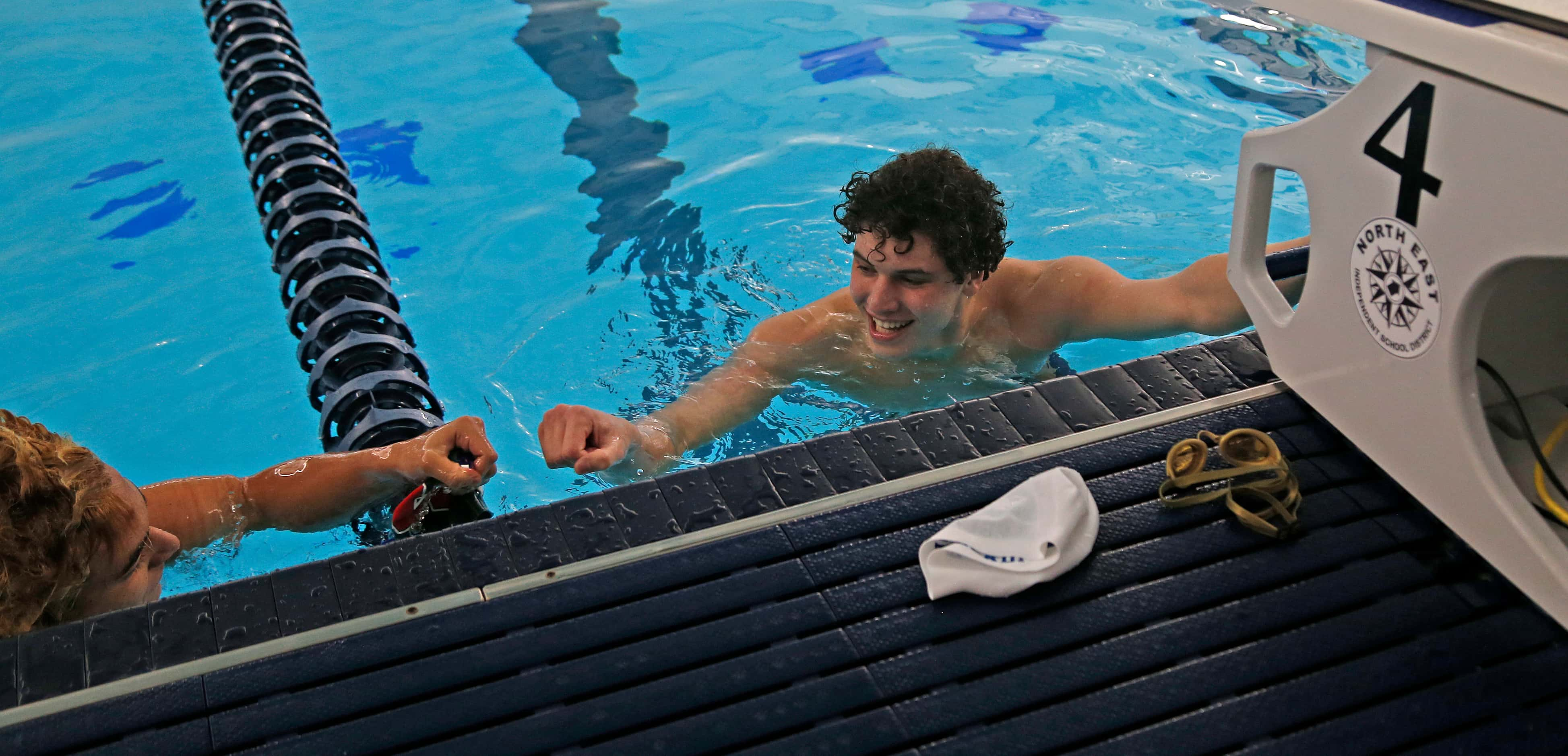 Keller's Noah Beladi gets congratulations after winning in boys 100 yard breastroke. UIL...