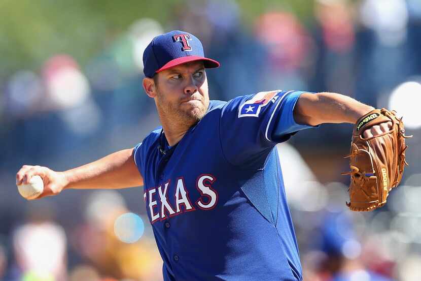 PEORIA, AZ - MARCH 09: Starting pitcher Colby Lewis #48 of the Texas Rangers pitches against...