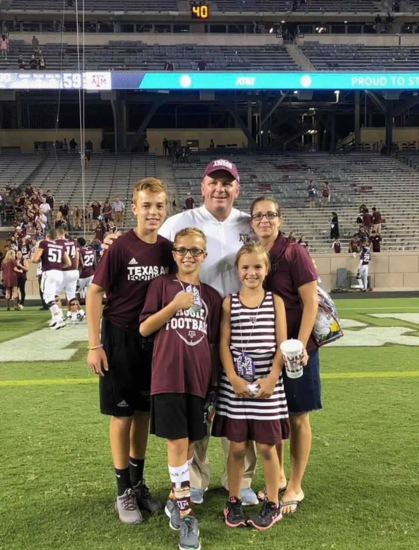 Mike Elko poses for a family photo at Kyle Field with (from left) his sons Michael and...