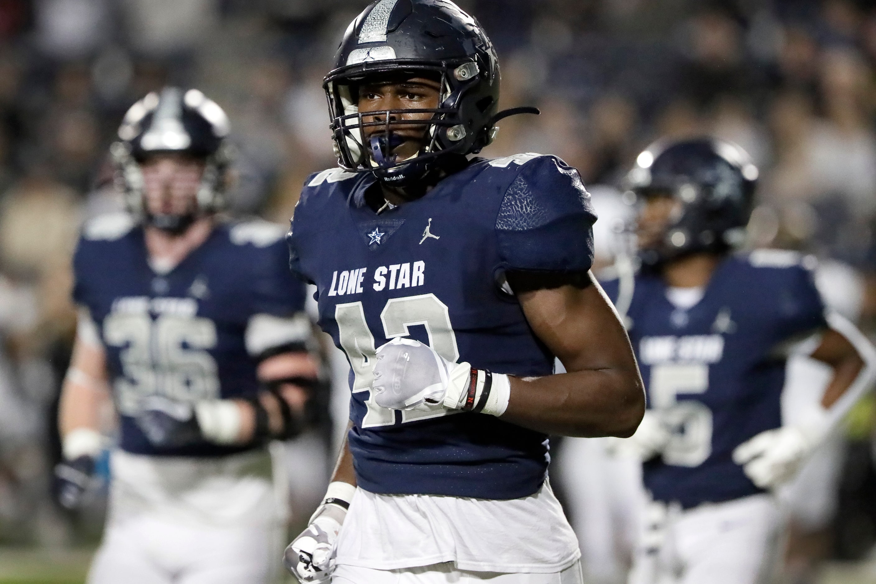 Lone Star High School defensive end Jaxon Lee (42) heads off the field during the first half...