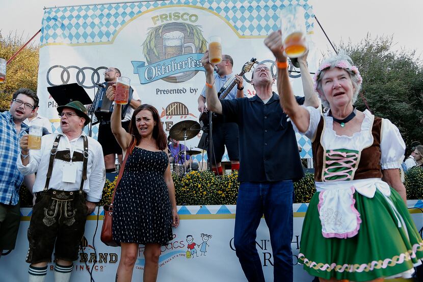 Beer drinkers sing the chorus in an audience participation song during Frisco’s Oktoberfest...