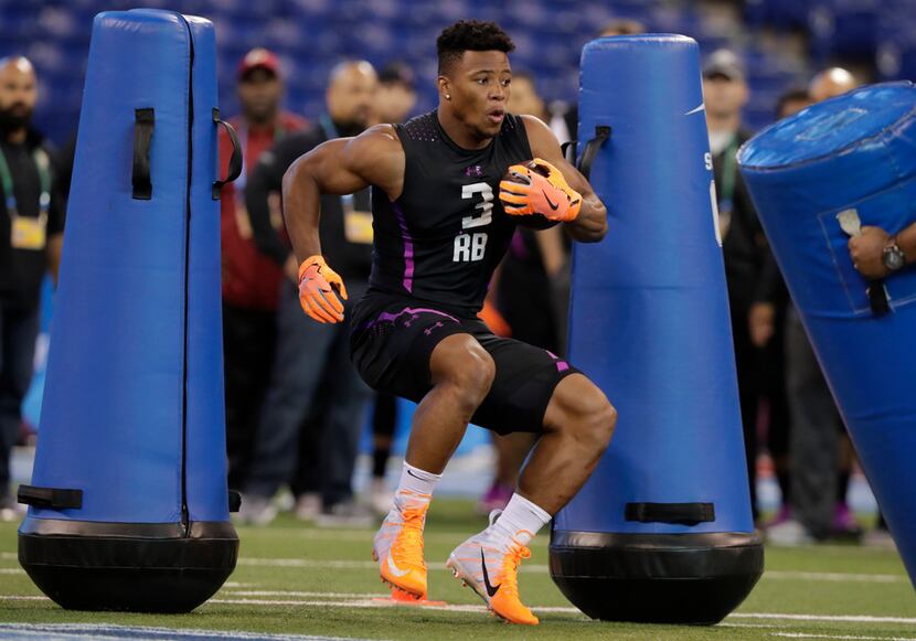 Penn State running back Saquon Barkley runs a drill at the NFL football scouting combine in...