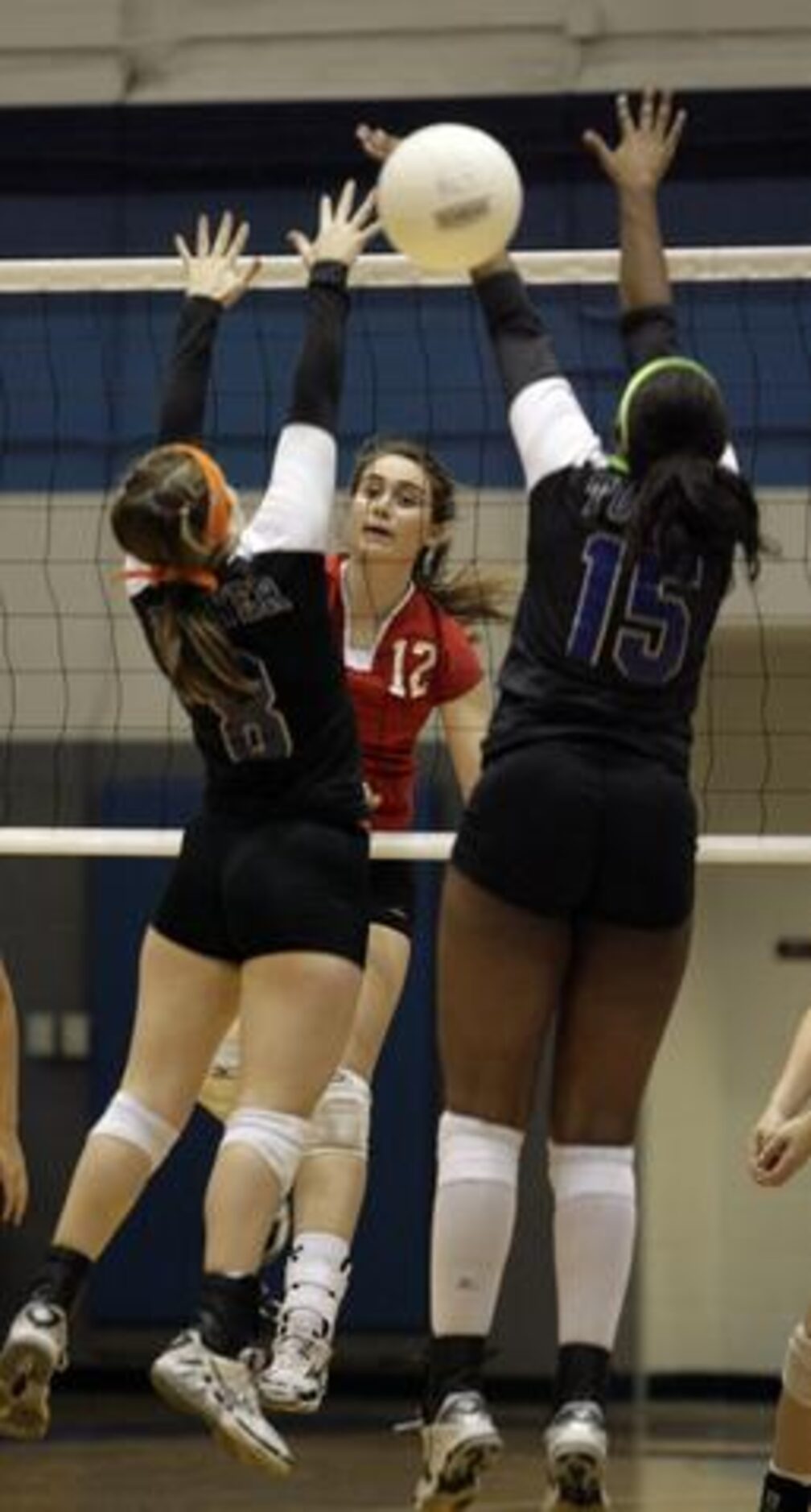 Richardson Pearce senior middle blocker Rachel Thibodeau (12) spikes between Carrollton R.L....