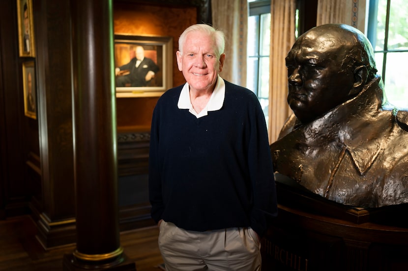 Harlan Crow stands next to a large bust of Winston Churchill displayed in his Highland Park...