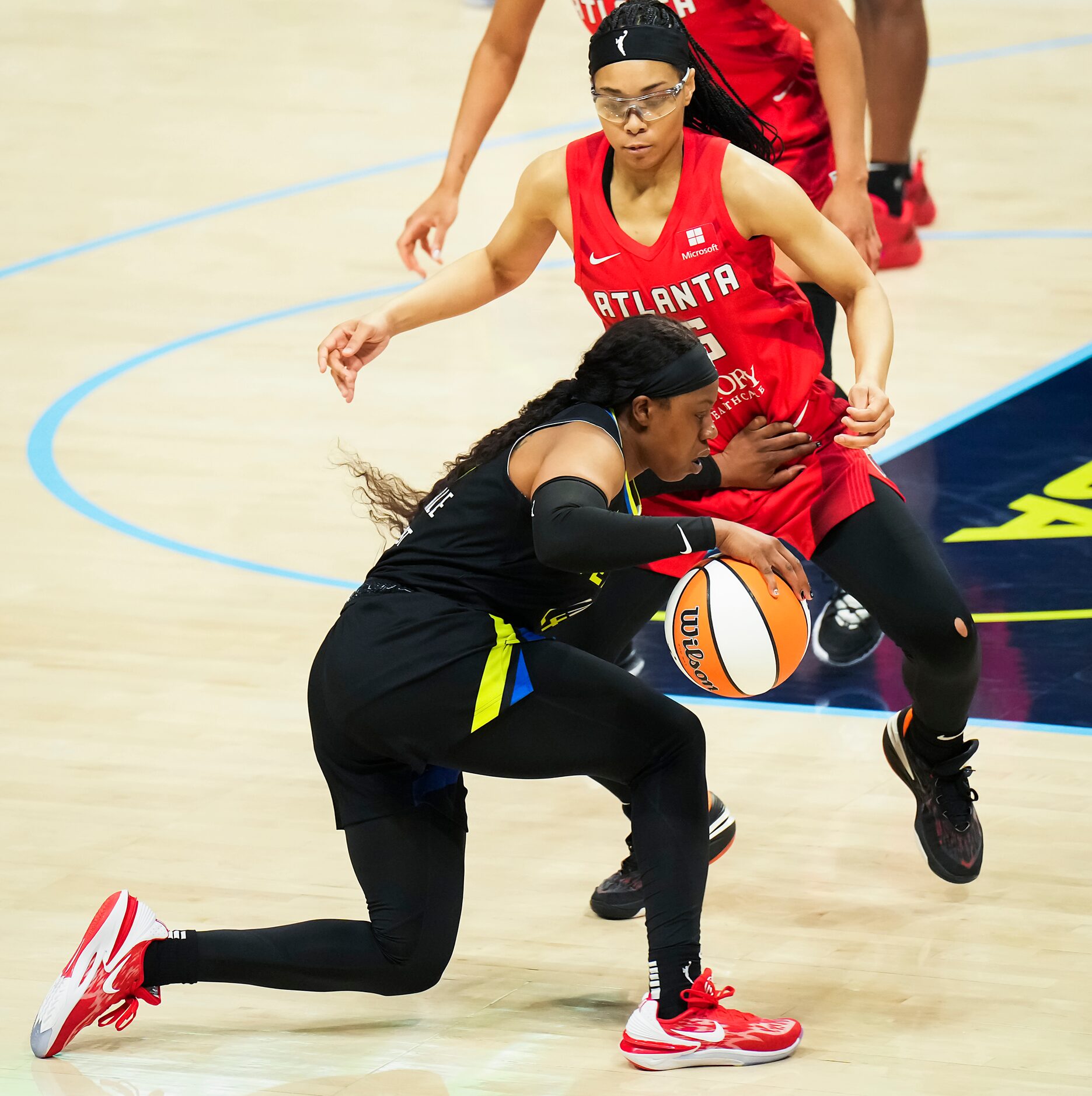 Dallas Wings guard Arike Ogunbowale (24) pushes away from Atlanta Dream guard Allisha Gray...