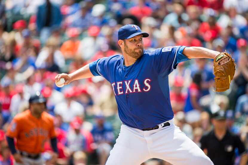 Texas Rangers starting pitcher Colby Lewis pitches during the first inning against the...