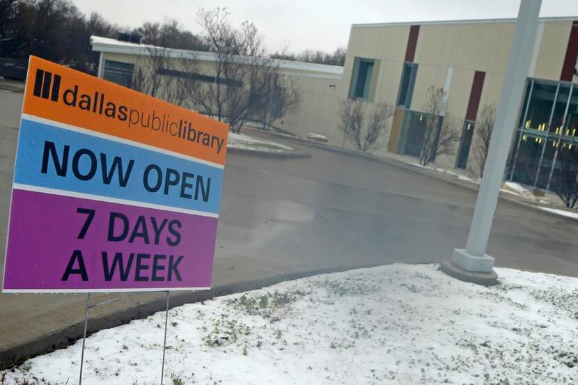 
A sign signals the fact that Dallas Public Library hours have changed outside of the White...