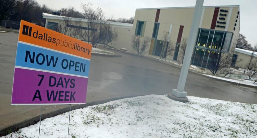 
A sign signals the fact that Dallas Public Library hours have changed outside of the White...