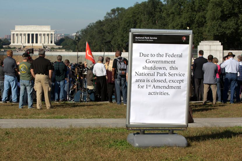 A sign is posted during a rally at the National World War II Memorial, Tuesday, Oct. 15,...