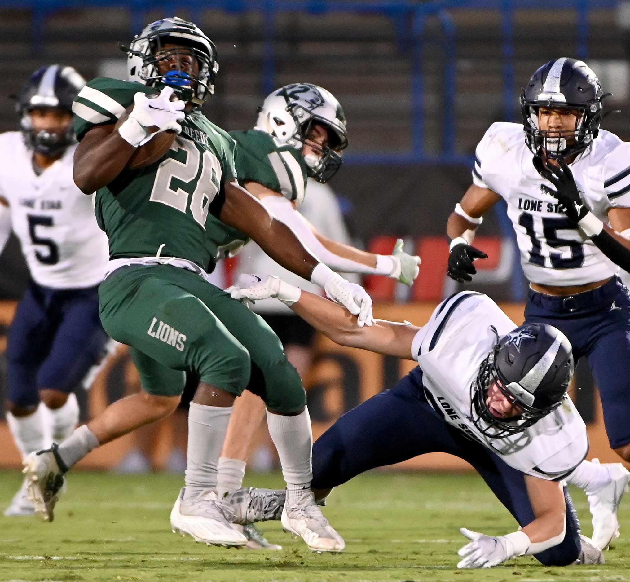 Frisco Reedy’s Aaron Daniels (26) spins out of a tackle attempt by Frisco Lone Star’s Zach...