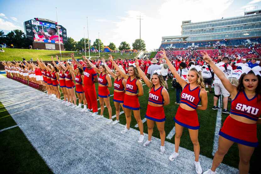 Southern Methodist Mustangs cheerleaders and football players celebrate after a 49-28 win...