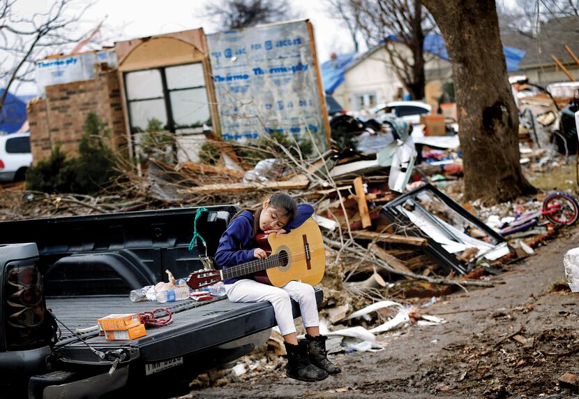 Natalie Rojas, 8, strummed a guitar found in the bedroom of her tornado-damaged home on...