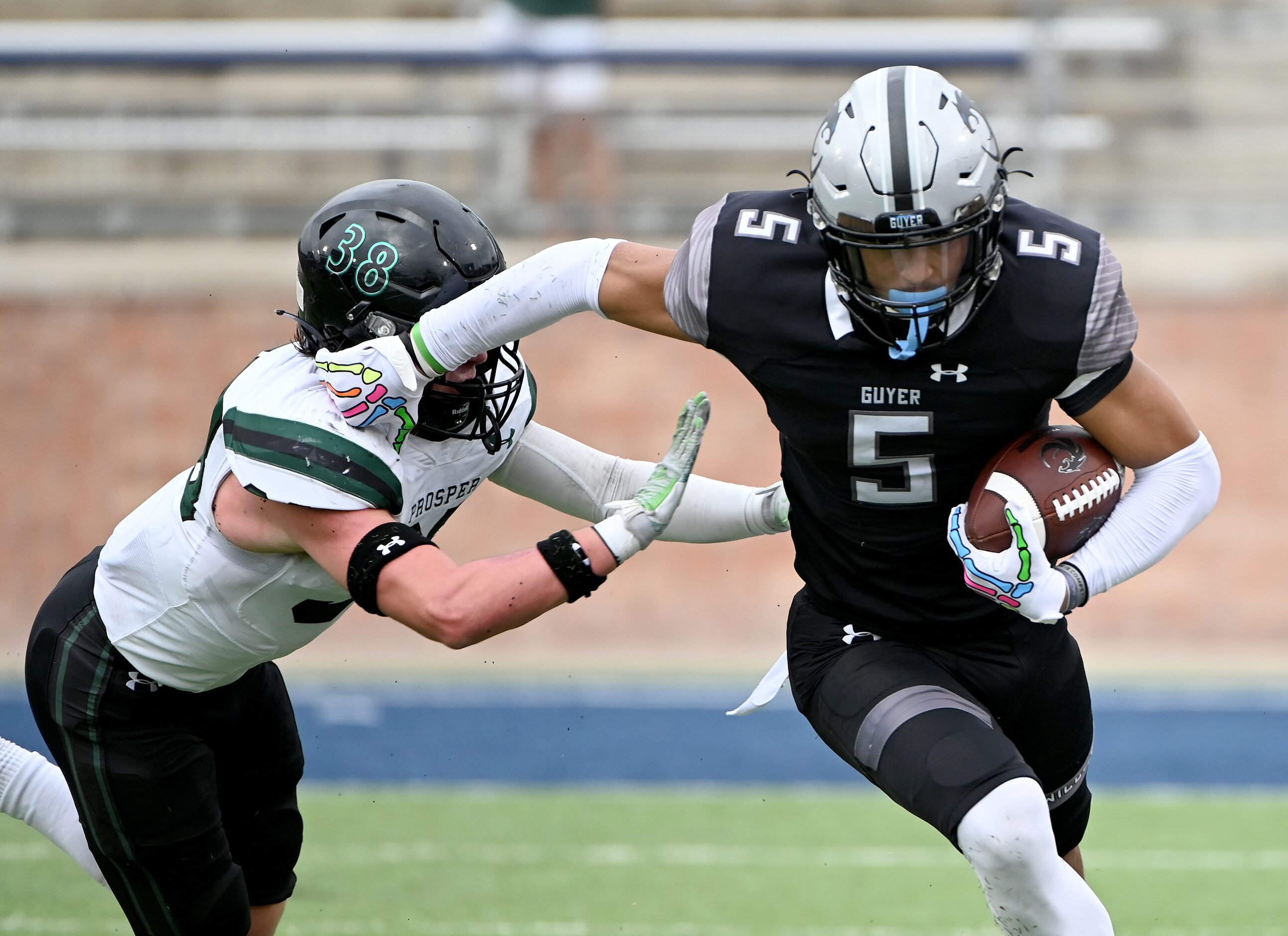 Denton Guyer's Jace Wilson (5) runs past Prosper's Jonah McClendon (38)  the first half of a...