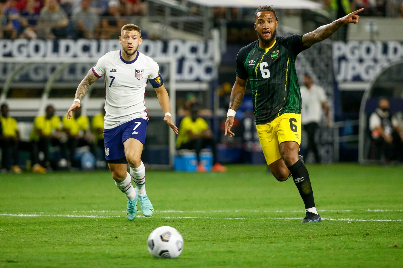 USA forward Paul Arriola (7) and Jamaica defender Liam Moore (6) chase the ball during the...