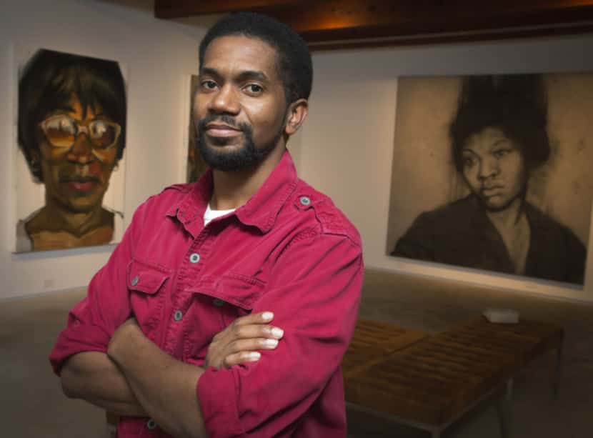 Artist Sedrick Huckaby poses with paintings of his mother, left, Ruthie Huckaby and his...