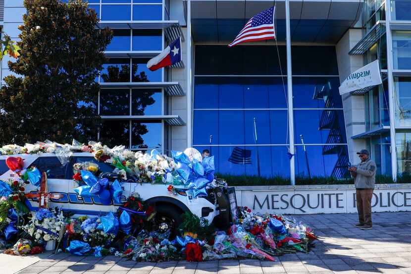 A memorial for Officer Richard Houston decorates a police car at Mesquite Police Department...