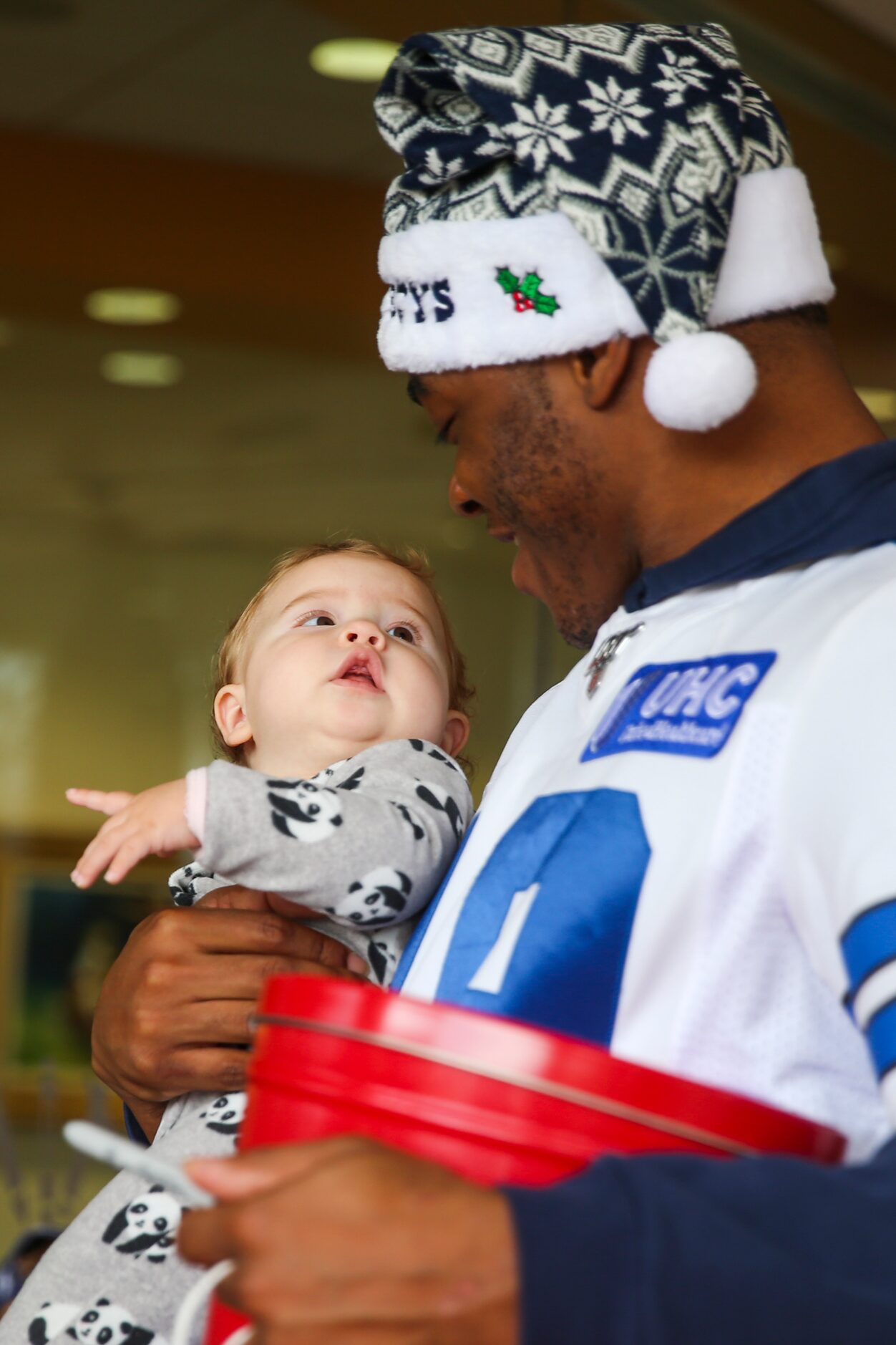 Dallas Cowboys wide receiver Amari Cooper (19) plays with Riley Donoghue, 3 months, during...