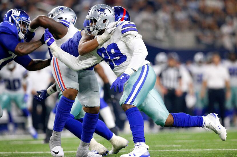 Dallas Cowboys defensive end Charles Tapper (99) races around New York Giants offensive...