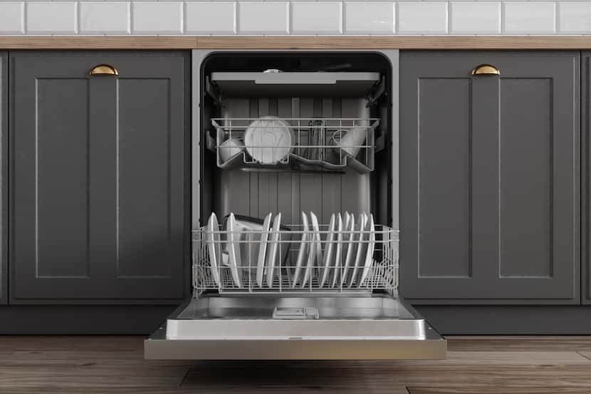 Open dishwasher with dishes inside, surrounded by streamlined gray cabinets