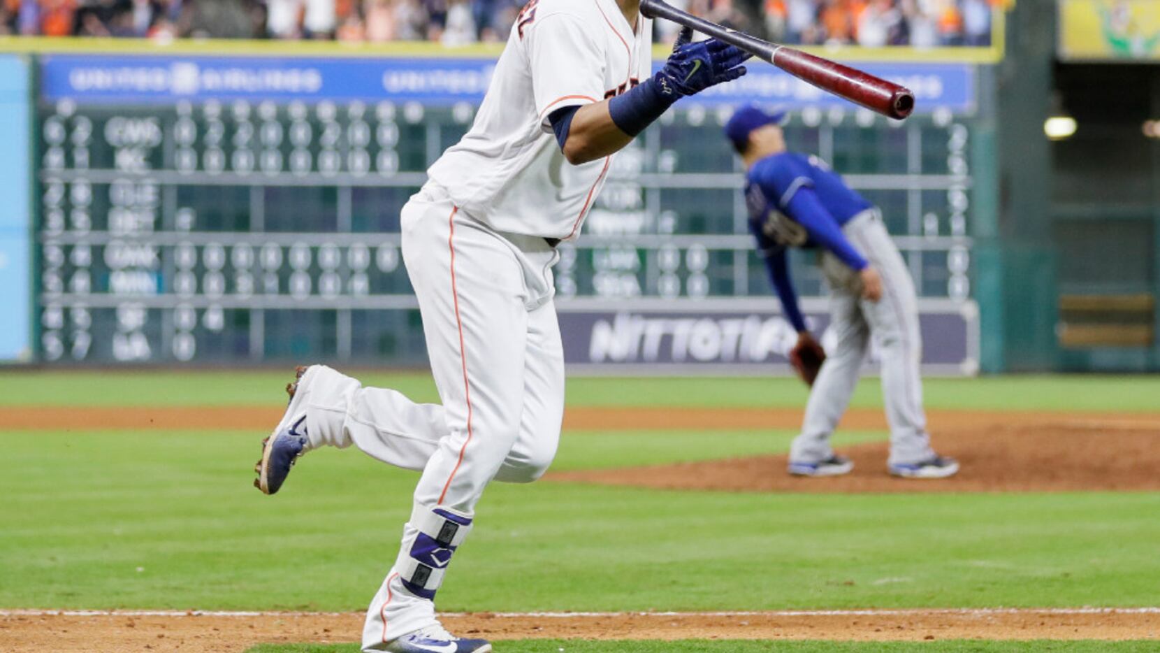 Houston Astros' Marwin Gonzalez tosses his bat after hitting a grand slam off Texas Rangers...