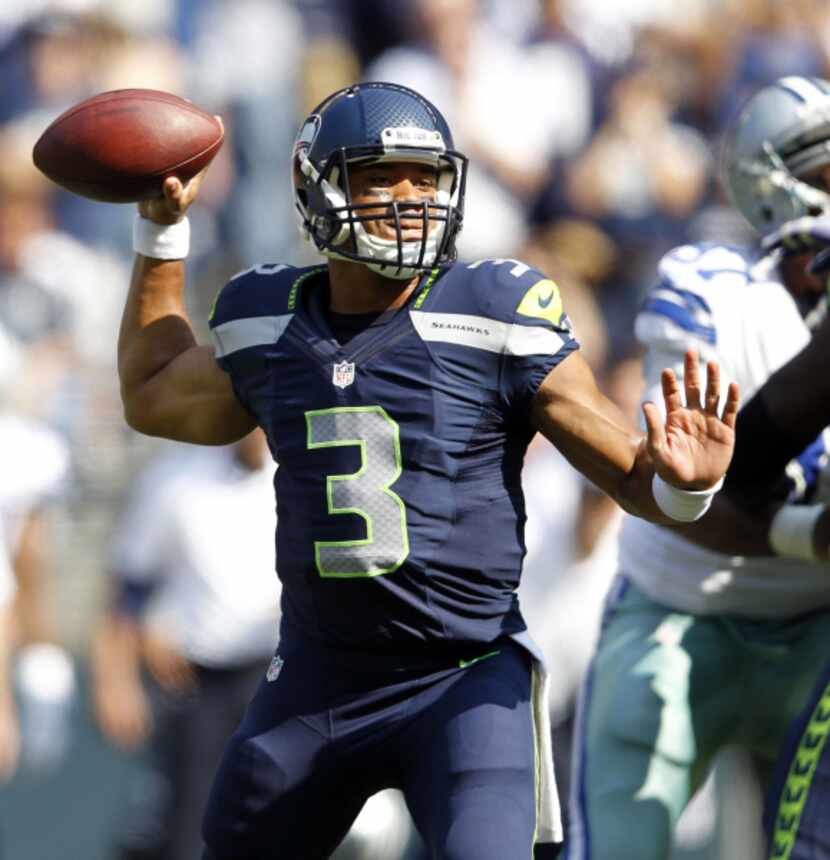 Seattle Seahawks quarterback Russell Wilson (3) looks to throw during the first half of play...