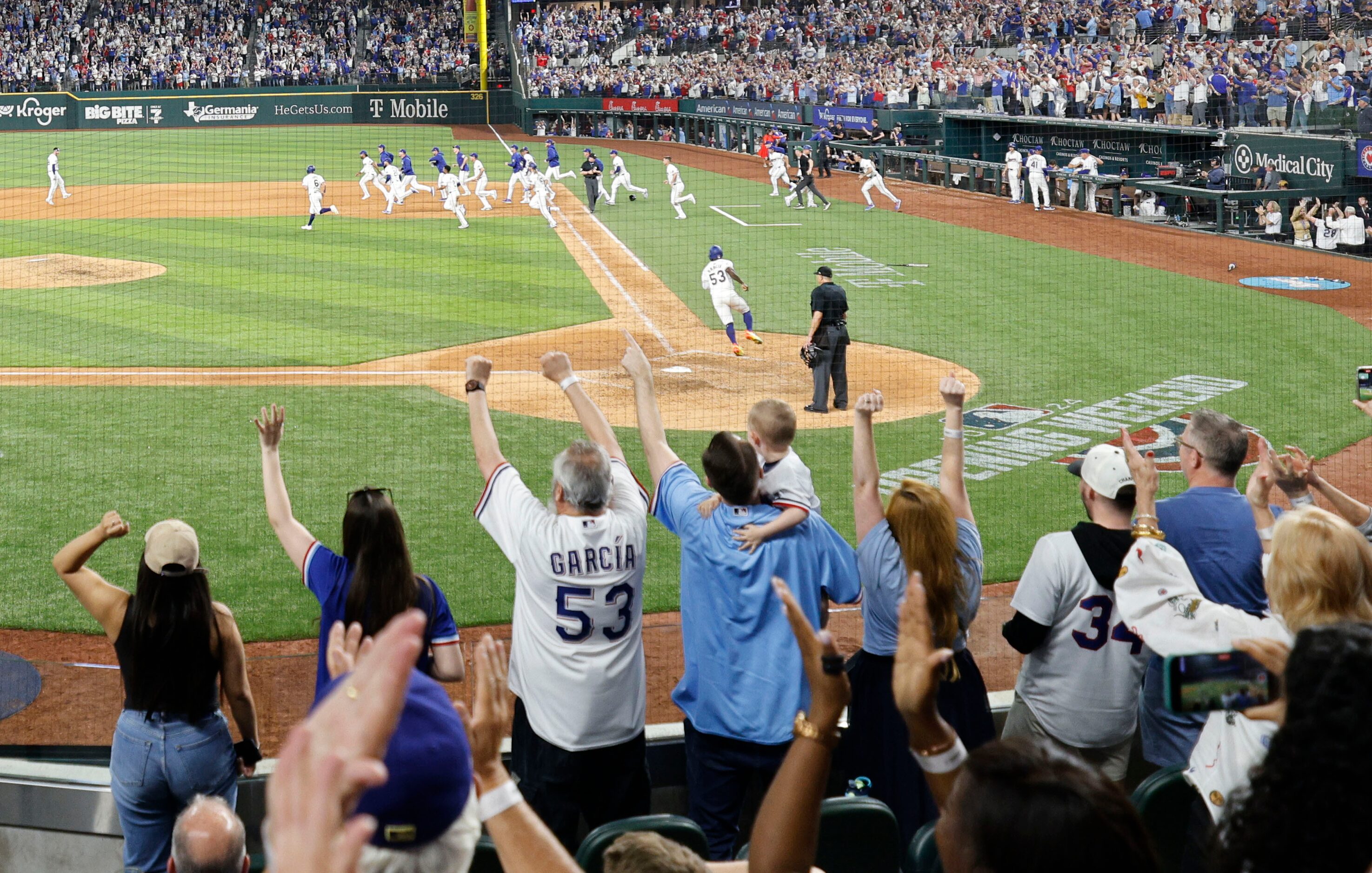 Fans celebrate Texas Rangers victory against the Chicago Cubs after an opening day baseball...