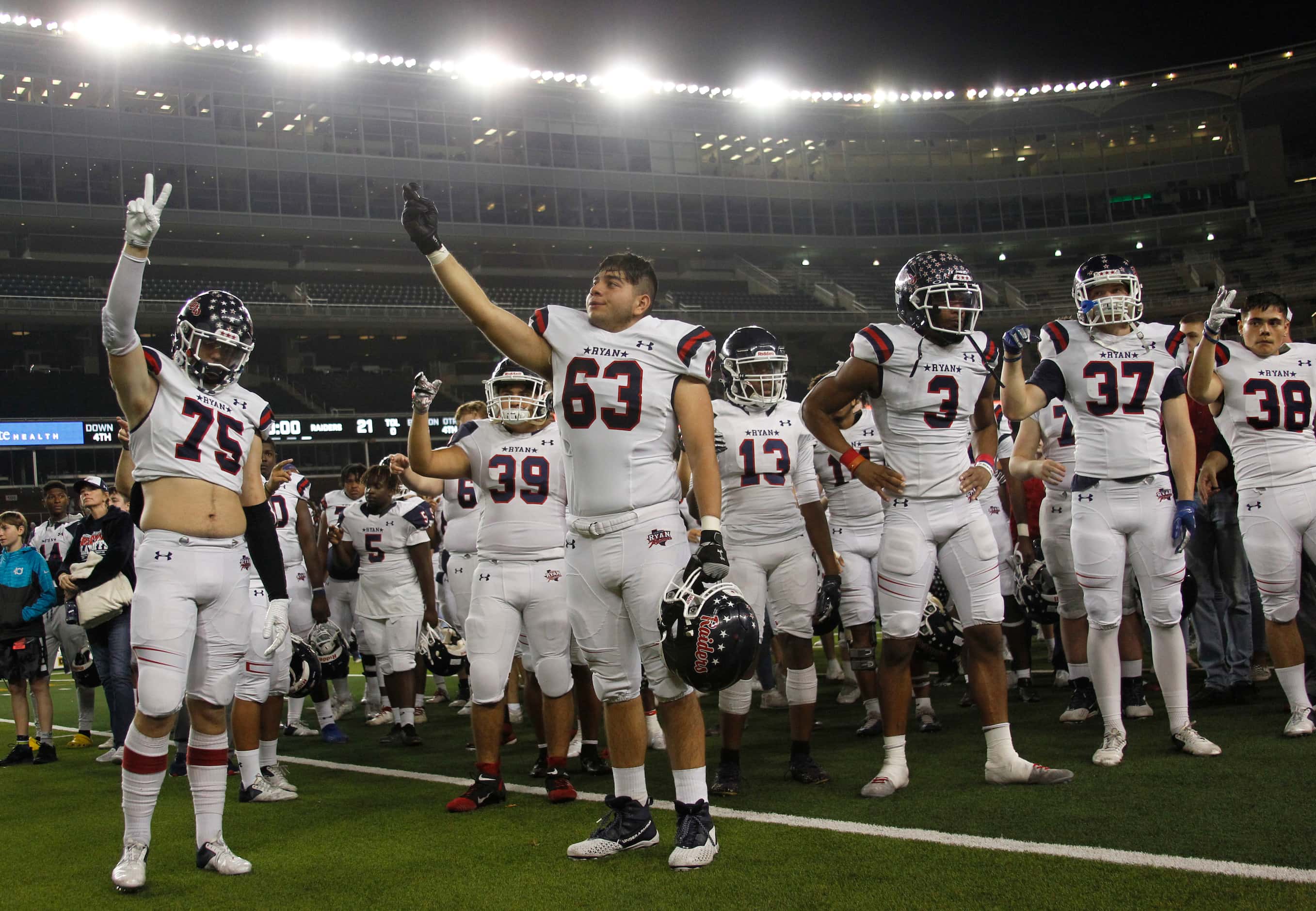 Denton Ryan Raiders pause for the playing of their school song following their 26-21 loss to...