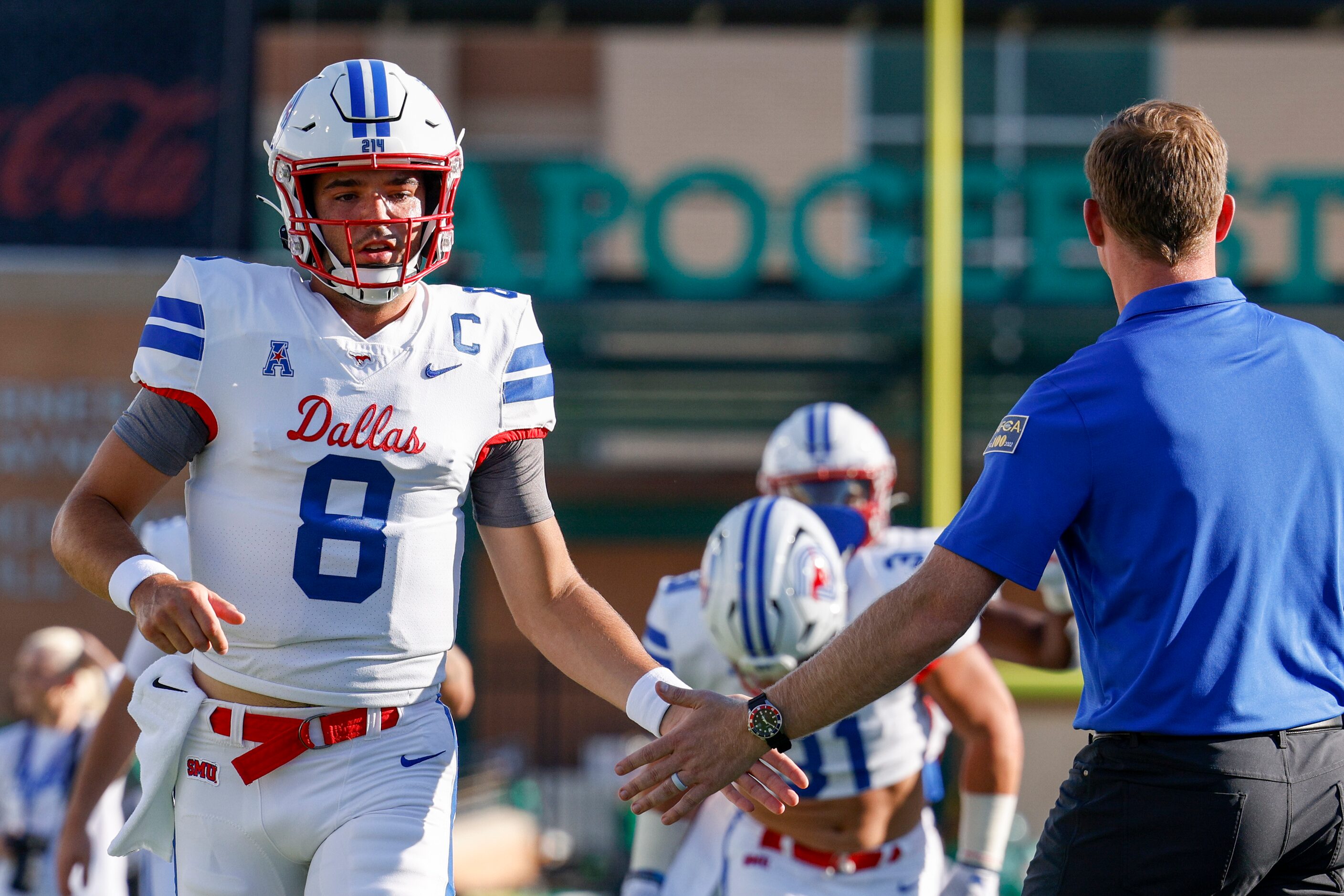 SMU head coach Rhett Lashlee high-fives SMU quarterback Tanner Mordecai (8) during warm-ups...