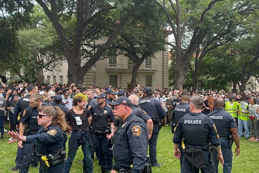 Police and state troopers try to disperse protesters at the University of Texas during a...