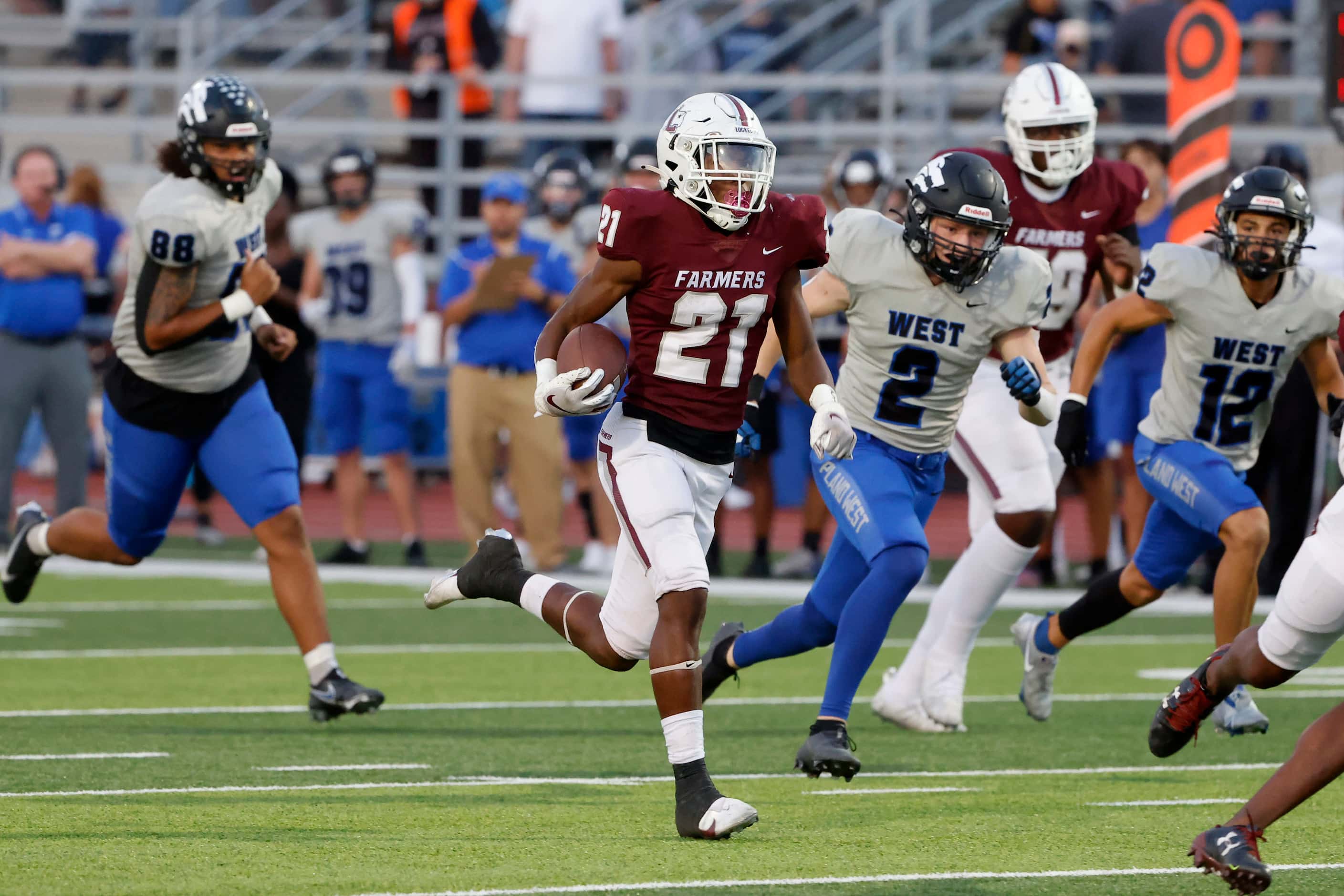 Lewisville running back Viron Ellison is chased by Plano West defender Reese Gunby (2) as he...