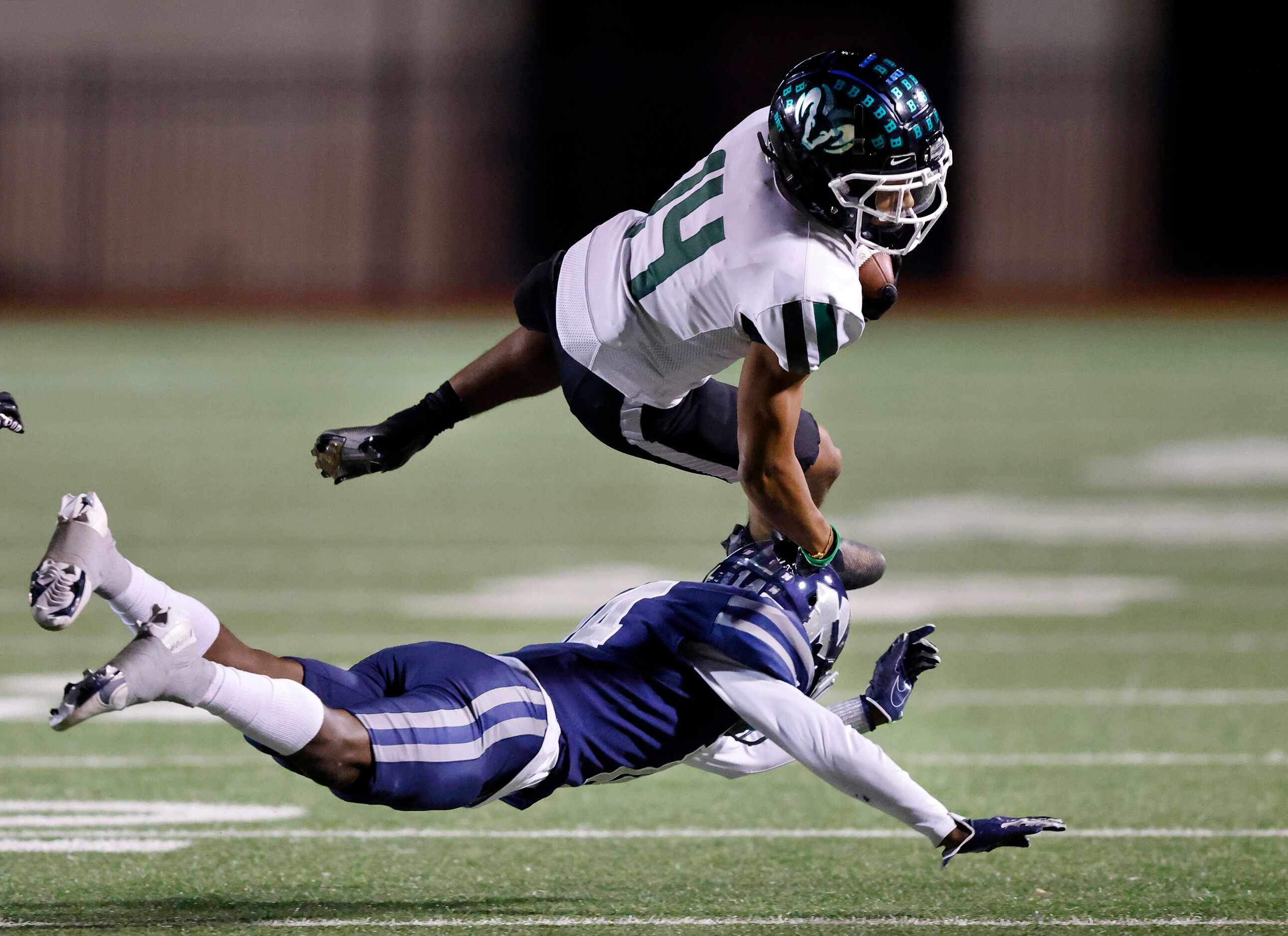 Richardson Berkner wide receiver Jamaal Saine (14) has his feet taken out from under him by...