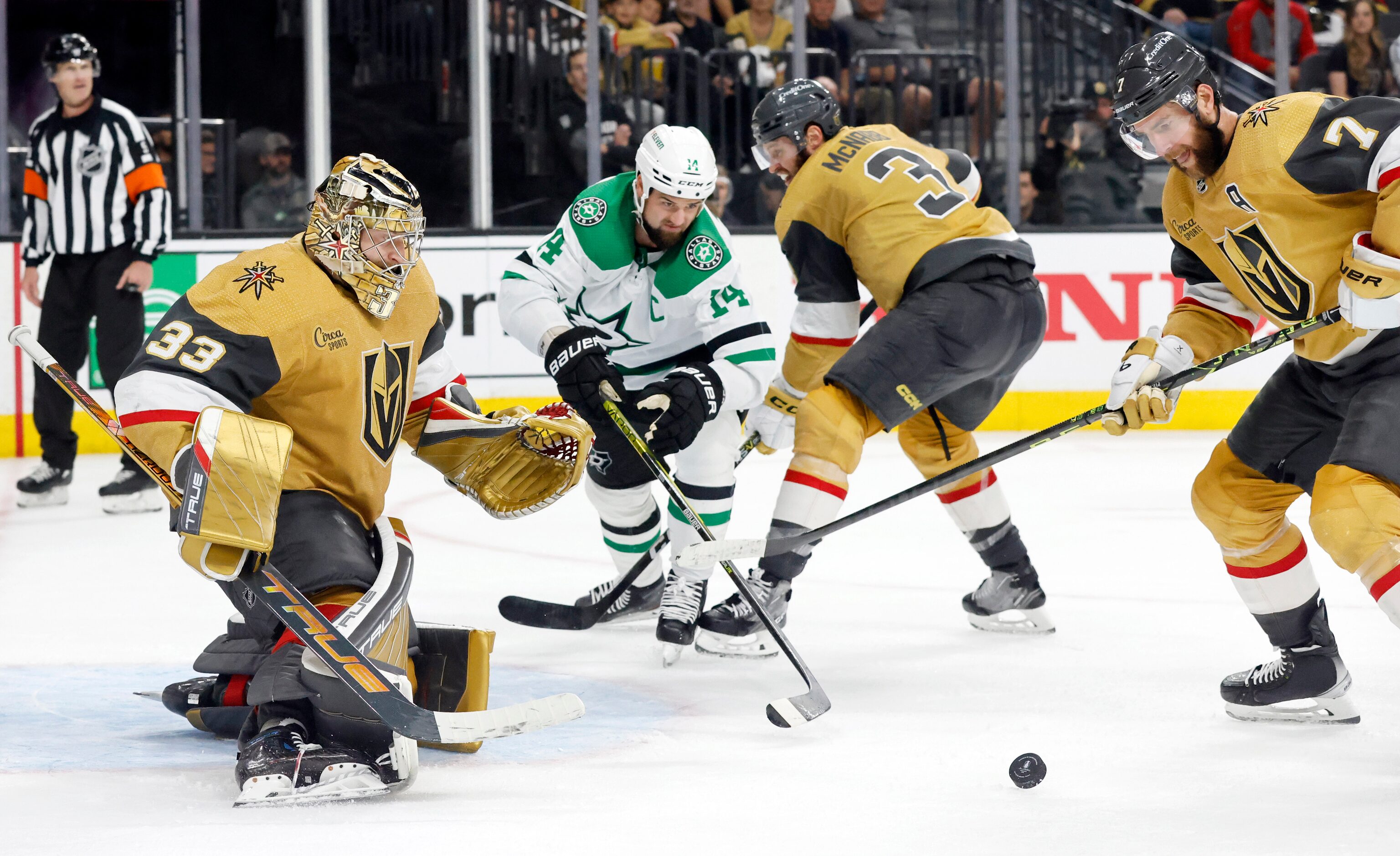 Dallas Stars left wing Jamie Benn (14) reaches for a loose puck in front of Vegas Golden...