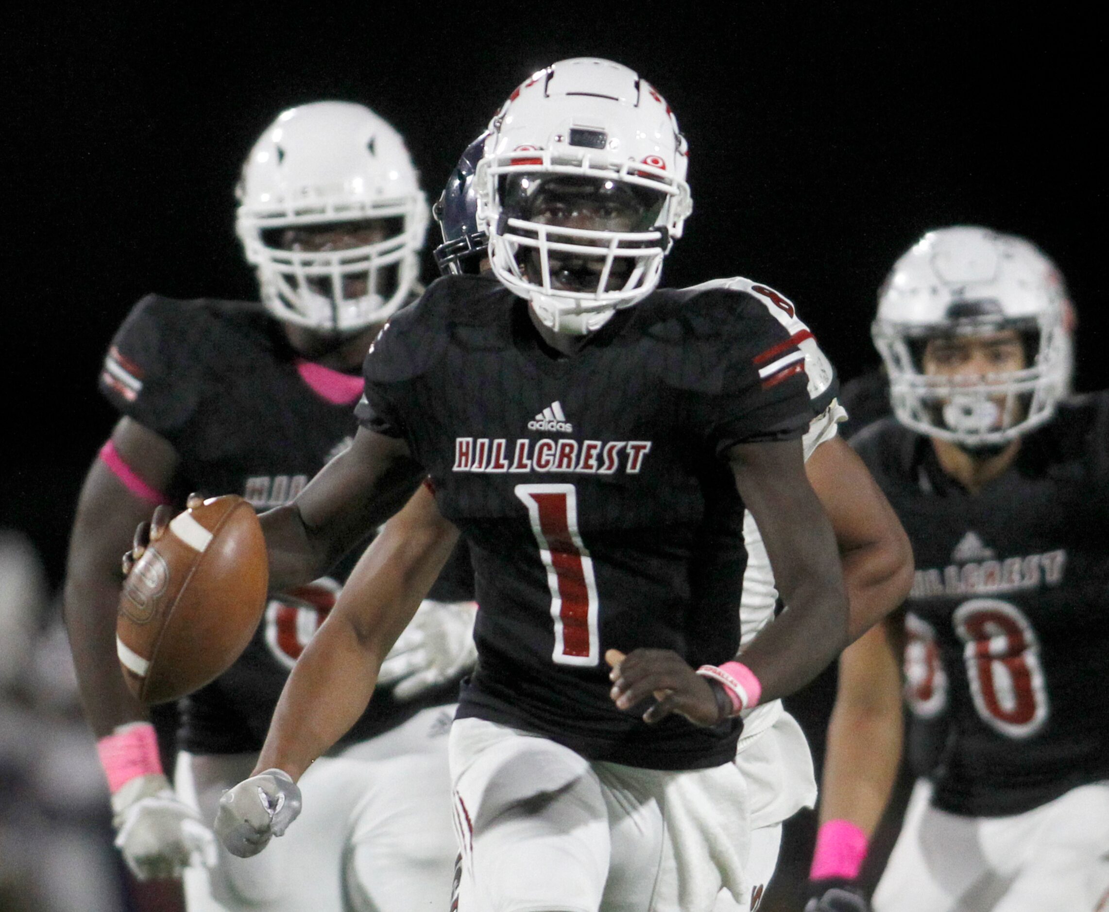 Dallas Hillcrest quarterback Carter Sido (1) looks to pass after rolling out of the pocket...