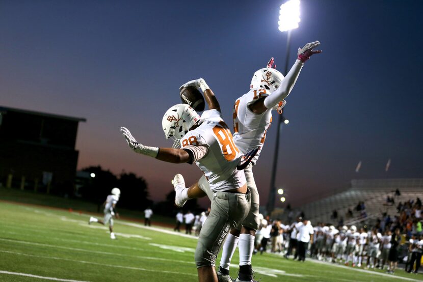 Bowie wide receiver Montez President (88) celebrates a touchdown with wide receiver Zaliek...