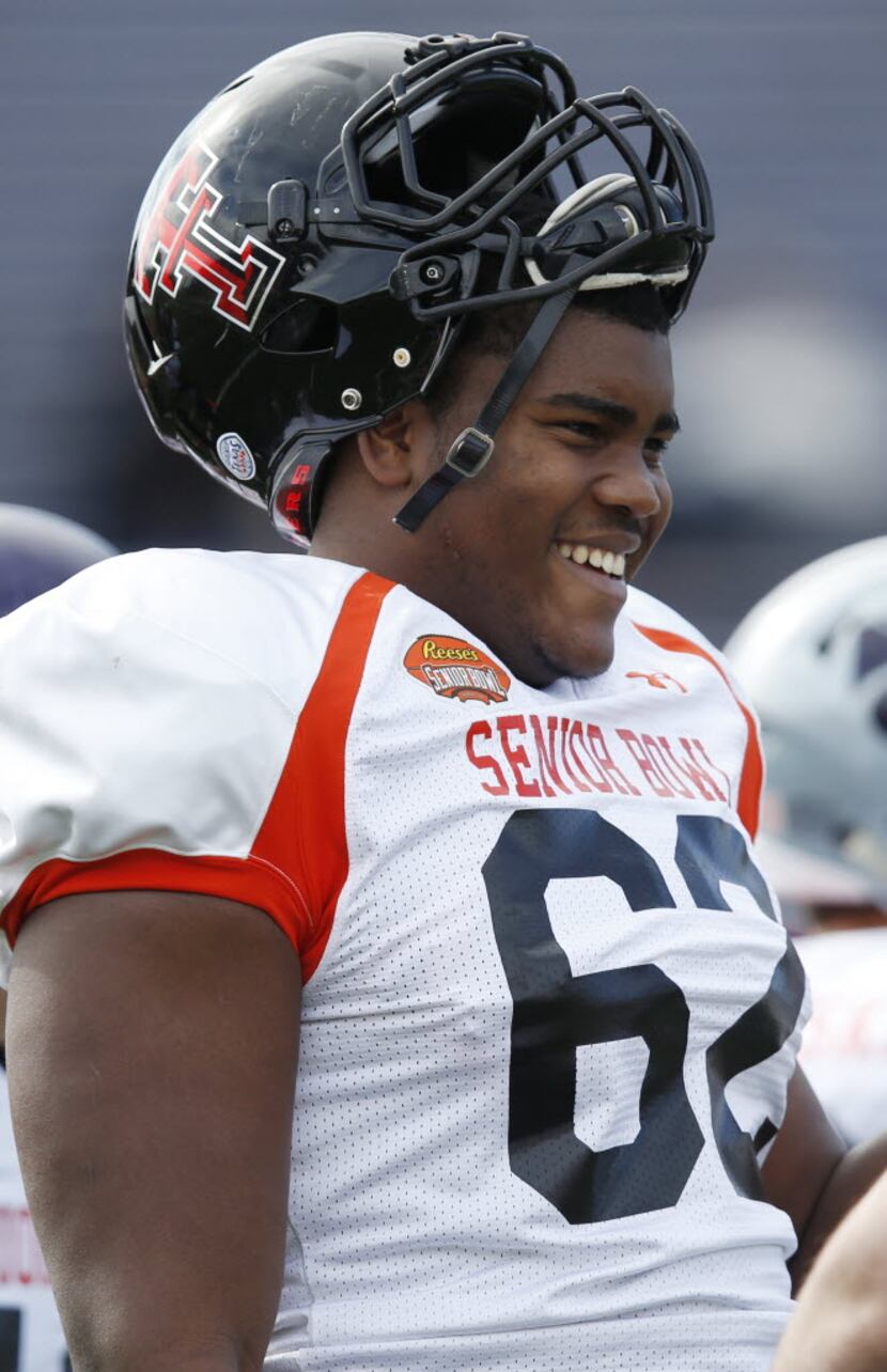 Texas Tech offensive tackle Le'Raven Clark laughs during NCAA college football practice for...