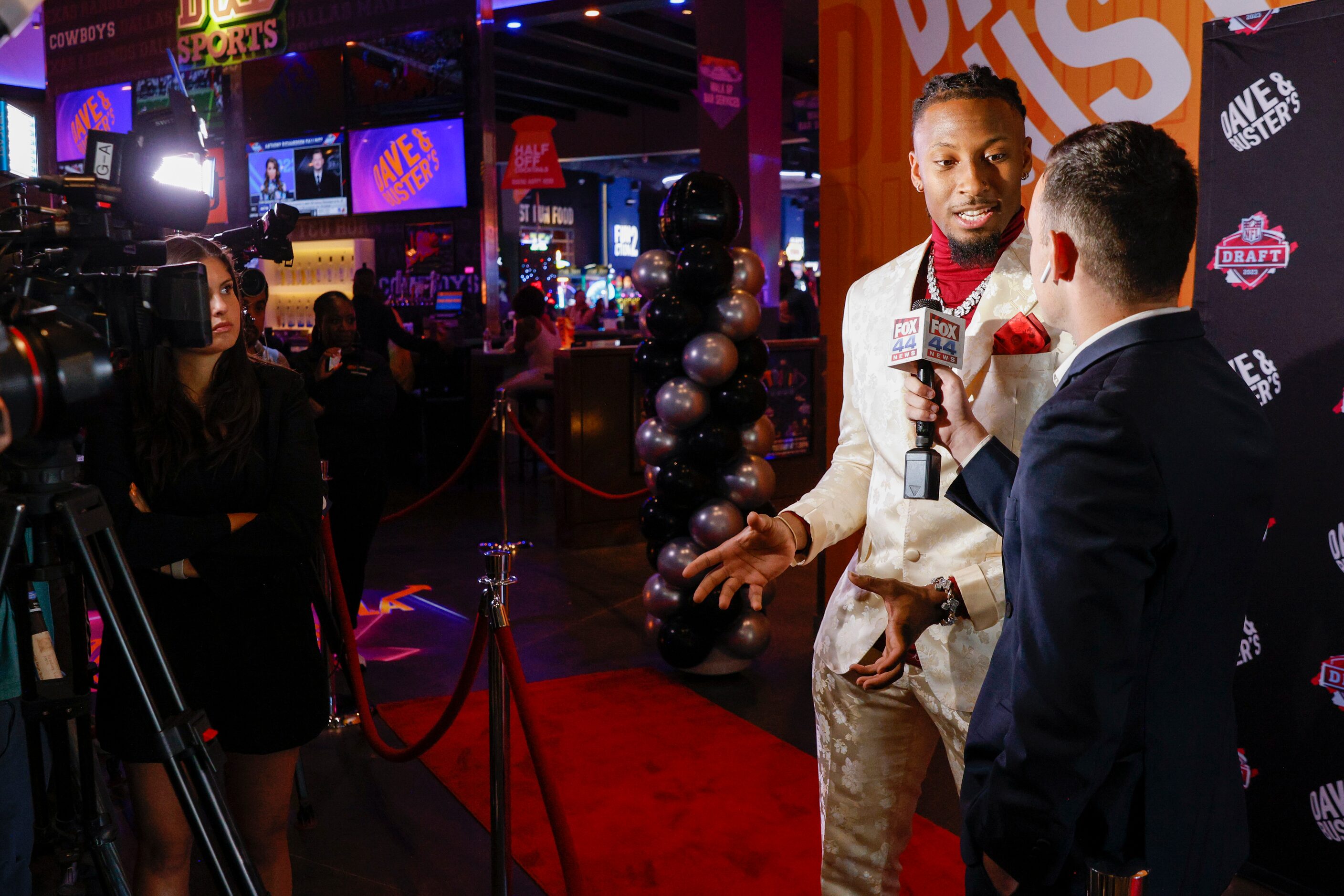 TCU wide receiver Quentin Johnston talks with reporters on the red carpet before a 2023 NFL...