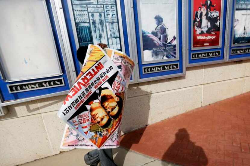 
A worker carts off posters for The Interview from a theater in Atlanta. The head of Sony...