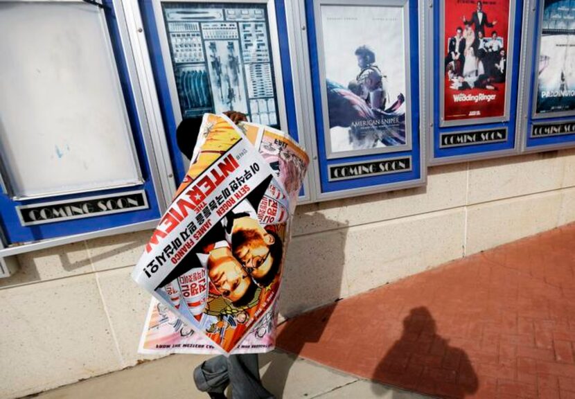 
A worker carts off posters for The Interview from a theater in Atlanta. The head of Sony...