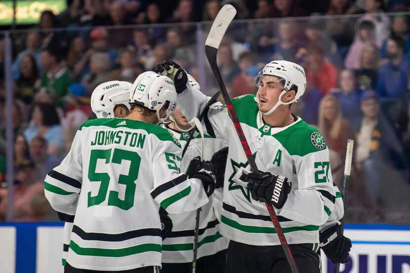 Dallas Stars left wing Mason Marchment (27) celebrates with teammates after scoring a goal...