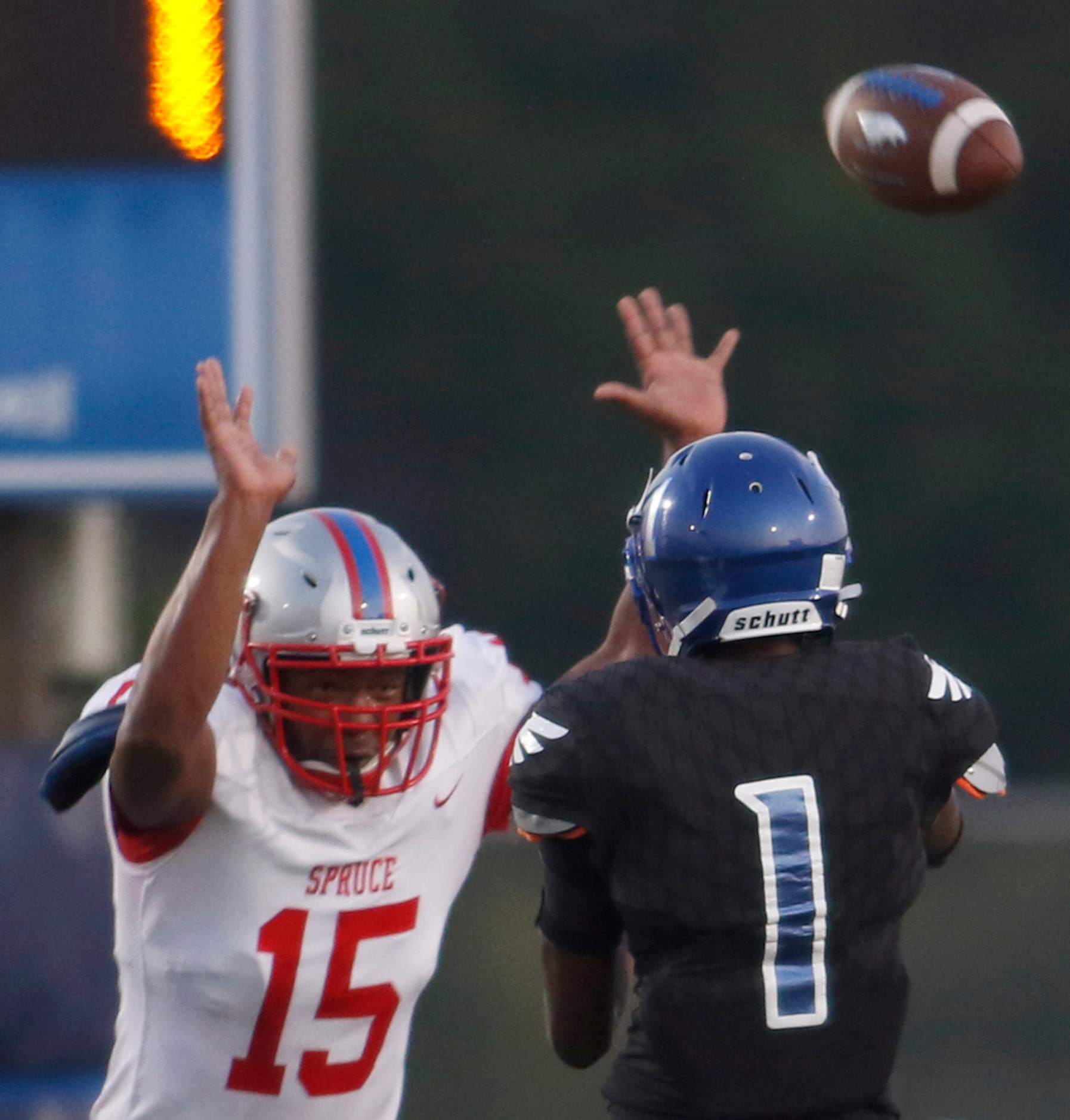 Wilmer Hutchins quarterback Bontay Duncan (1) gets a pass off just ahead of the pressure...