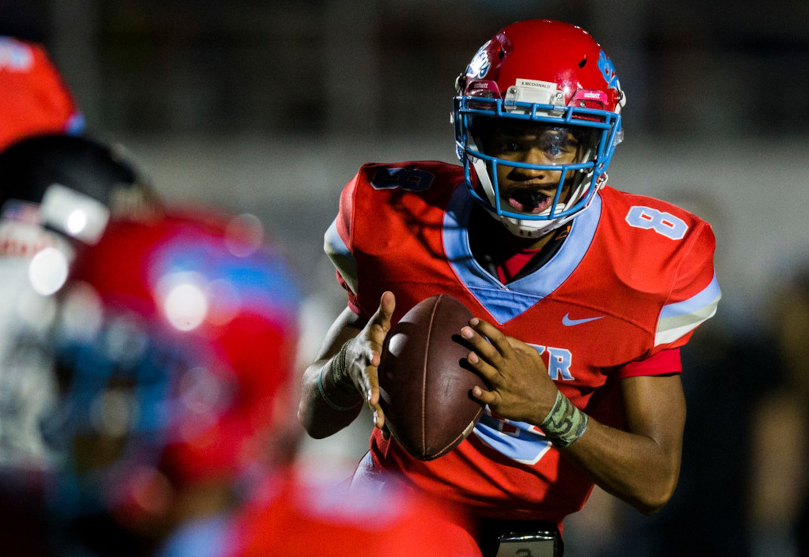 Carter quarterback Xavier McDonald (8) looks for a receiver during the second quarter of a...