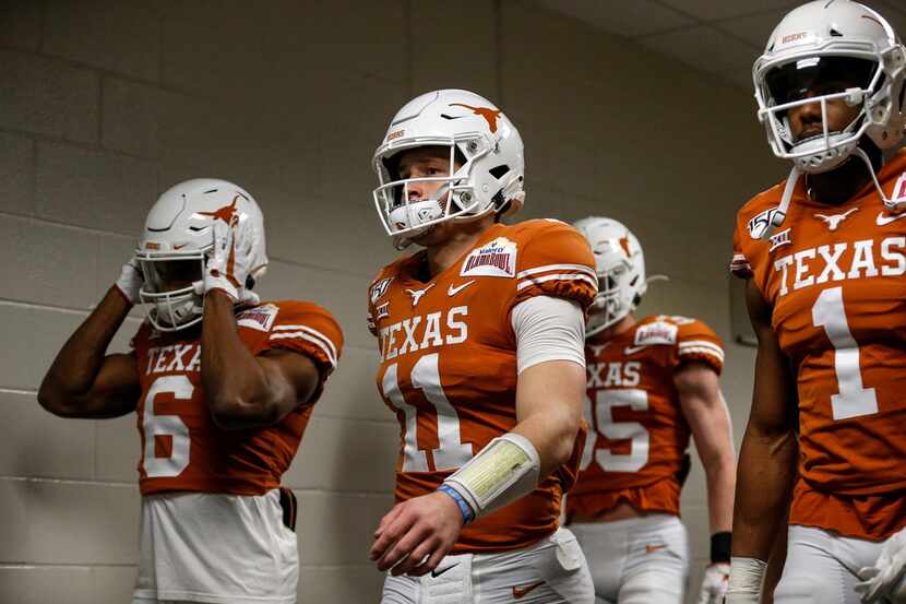 Texas quarterback Sam Ehlinger (11) leads the Longhorns out of the tunnel before the Alamo...