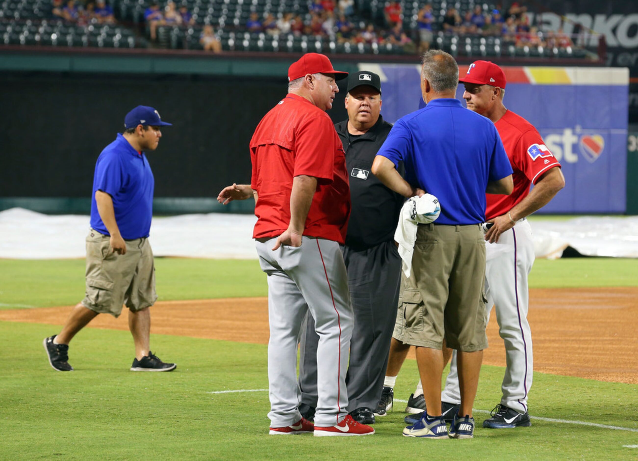 Artist Vernon Wells unveils a painting that was presented to Texas Rangers' Bartolo Colon...