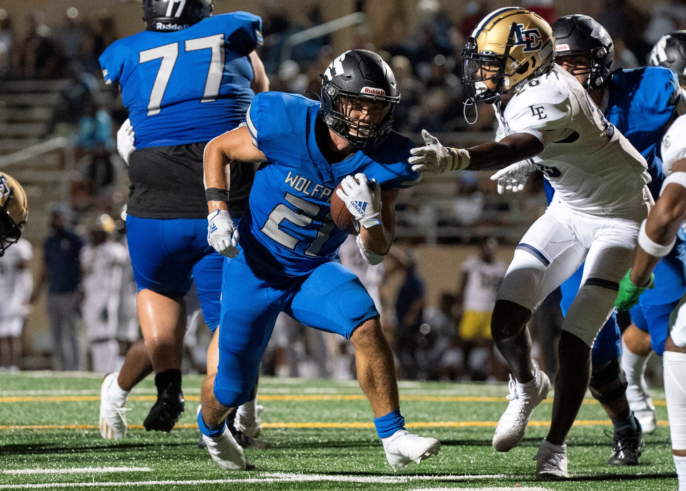 Plano West junior running back Dermot White (21) cuts away from Little Elm junior defensive...