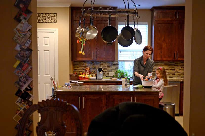 
Danika Mendrygal makes dinner with daughter McKenna, 3, at their Uptown townhome. “Our...