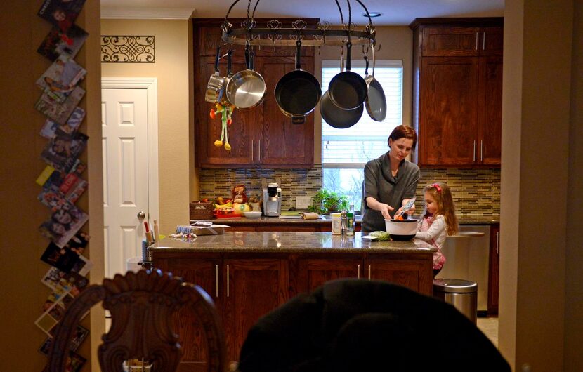 
Danika Mendrygal makes dinner with daughter McKenna, 3, at their Uptown townhome. “Our...