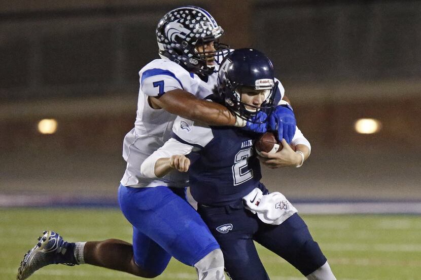 Allen High School quarterback Mitchell Jonke (2) is tackled from behind by Plano West High...